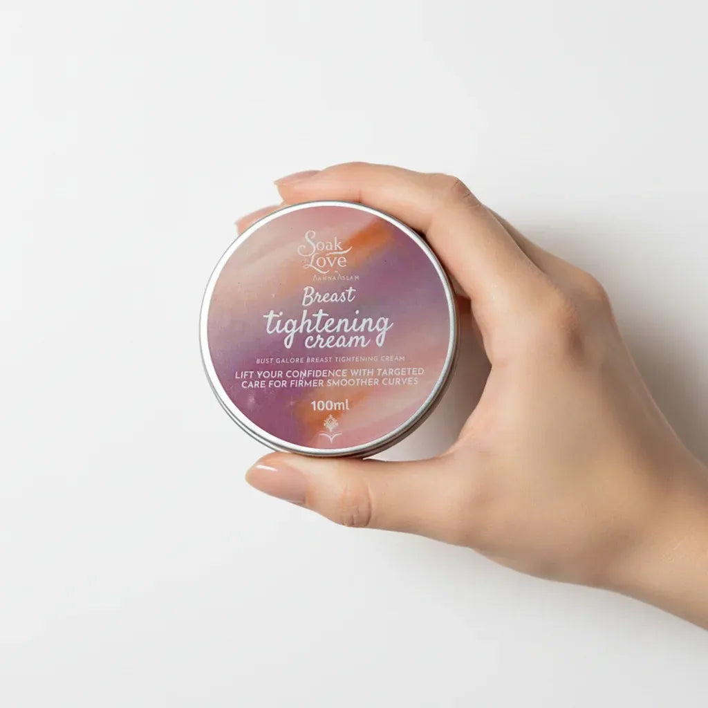 100ml Breast Tightening Cream in a cosmetic jar with a pink label, designed to moisturize and improve the appearance of firmer, smoother skin.